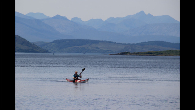 Entering Loch Duich, Cuillins of Skye behind Sea Kayak Loch Duich Eilean Donan Castle