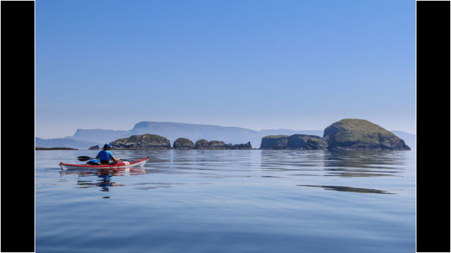 Lord Macdonald's Table, Gaeilavore Island, Skye behind Sea Kayak Fladda-chuain Skye