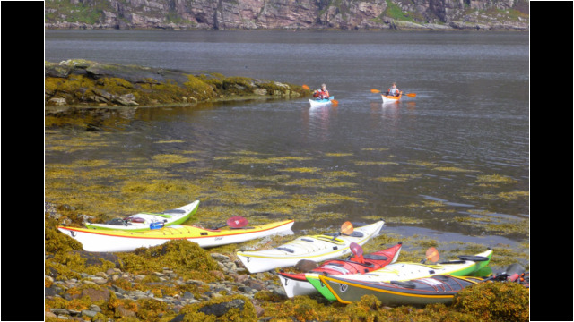Landing in bay on NE corner of Isle Martin Sea Kayak Isle Martin Loch Broom North West Highlands